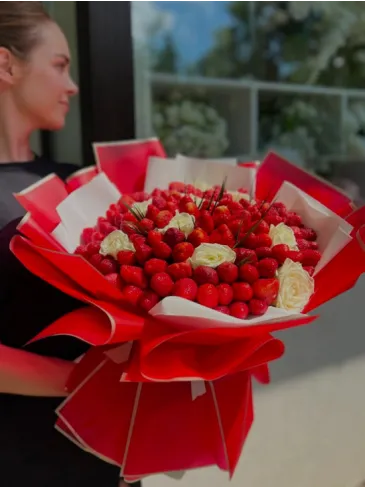 A bouquet of strawberries and white roses