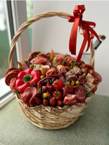 Корзина с мясными закусками и свежими овощами